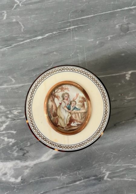 Null 象牙和玳瑁的圆盒，装饰有一个代表母亲和她的孩子的椭圆形微型画。 19世纪初。 直径：7.5厘米。