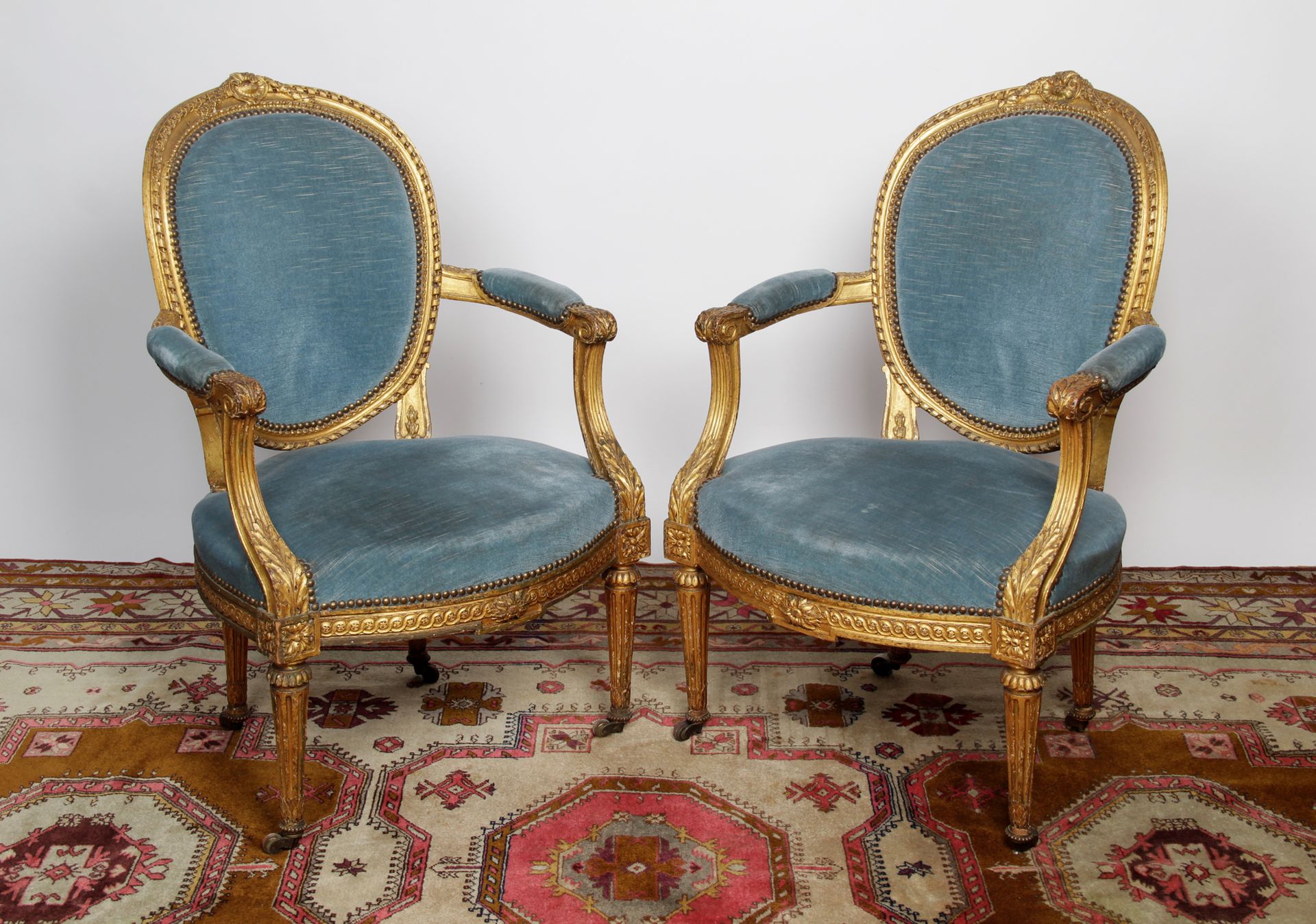 Null TWO ARMCHAIRS with medallion backs in molded, carved and gilded wood, decor&hellip;