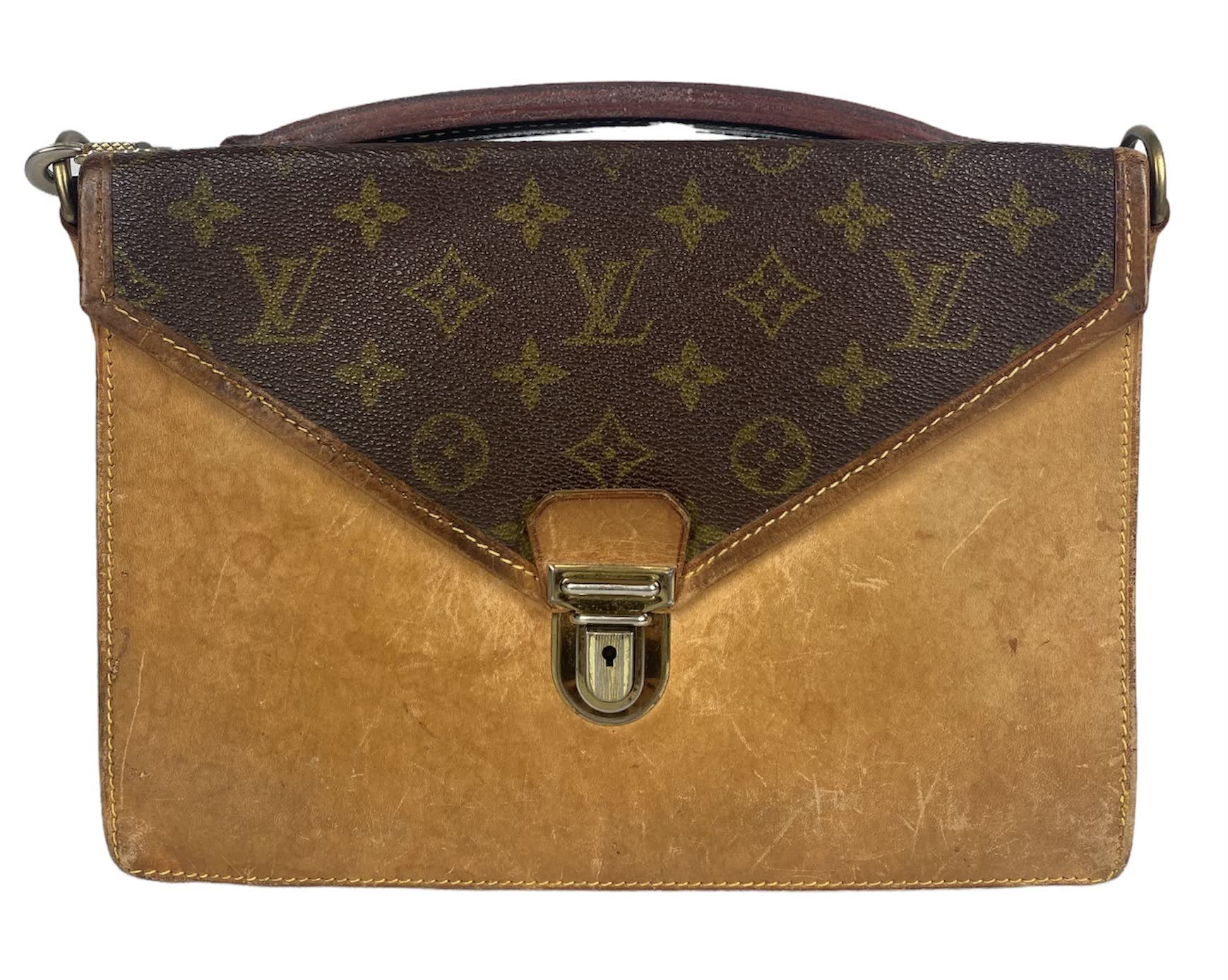 Null LOUIS VUITTON Leather and canvas monogrammed clutch bag with double flaps. &hellip;