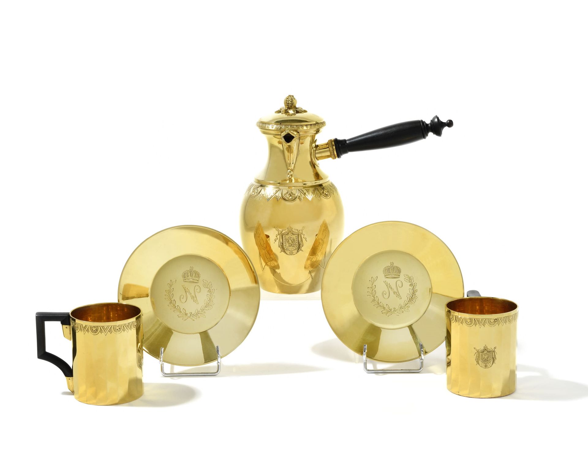 Null * 拿破仑皇帝的服务的再版 
镀金的咖啡服务包括; 
- 两个杯子，侧面刻有几何图案和皇室徽章。 
木质手柄。杯子下面刻有数字N，上面是橡树叶和月桂冠&hellip;