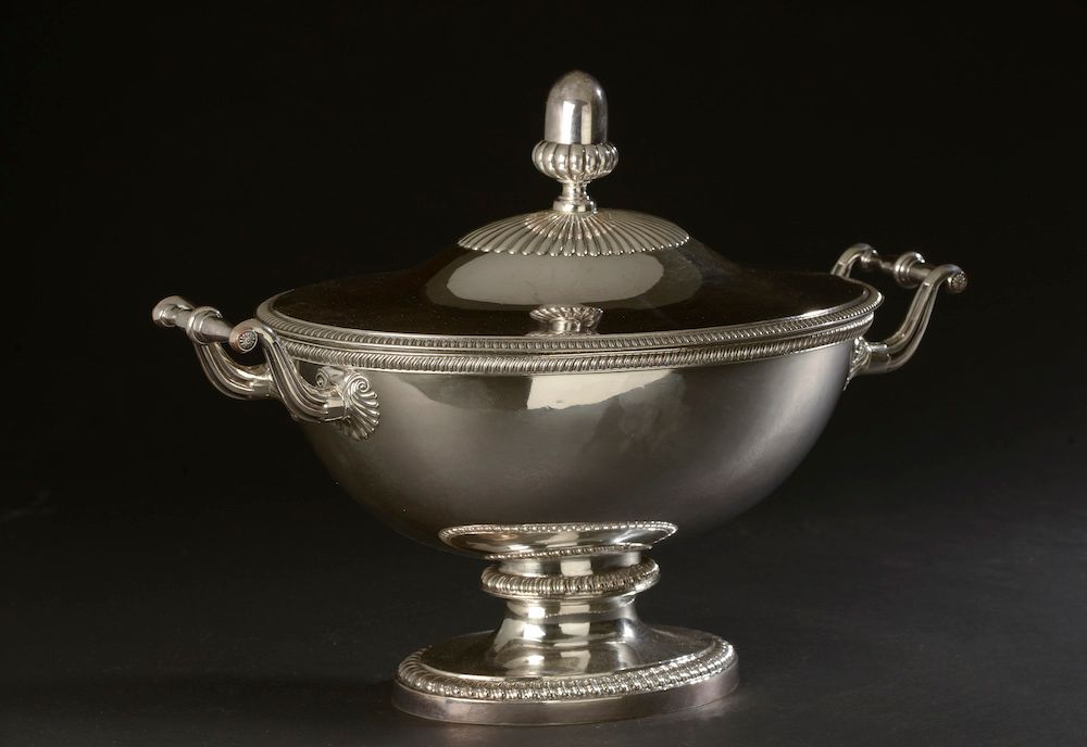Null A large doubled metal tureen on a pedestal, the whole underlined by friezes&hellip;