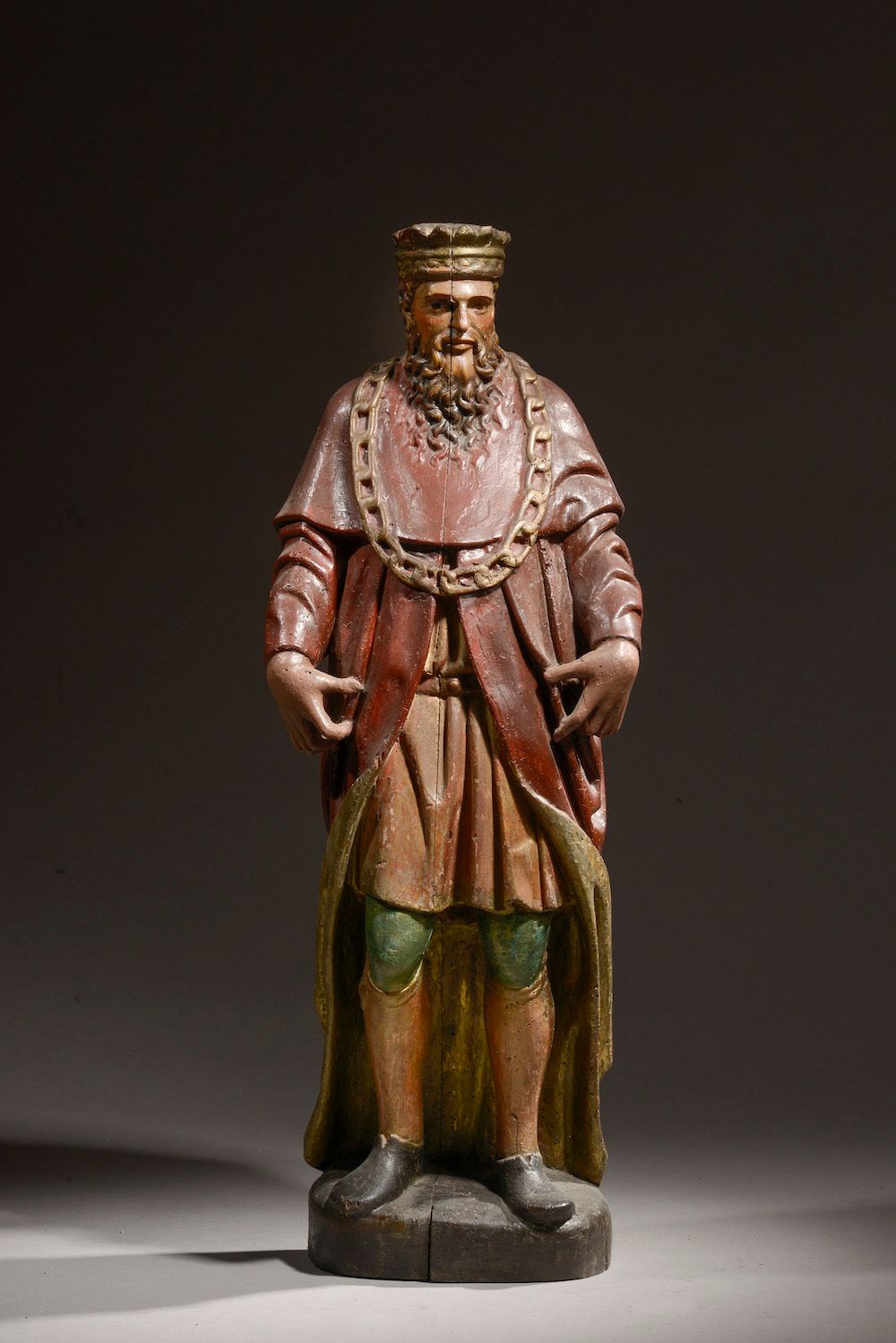 Null 代表一个加冕的国王的雕像，可能戴着金羊毛的链子，用木头雕刻，重新上色和重新上漆。

18世纪。

高度：81厘米。高度：81厘米
