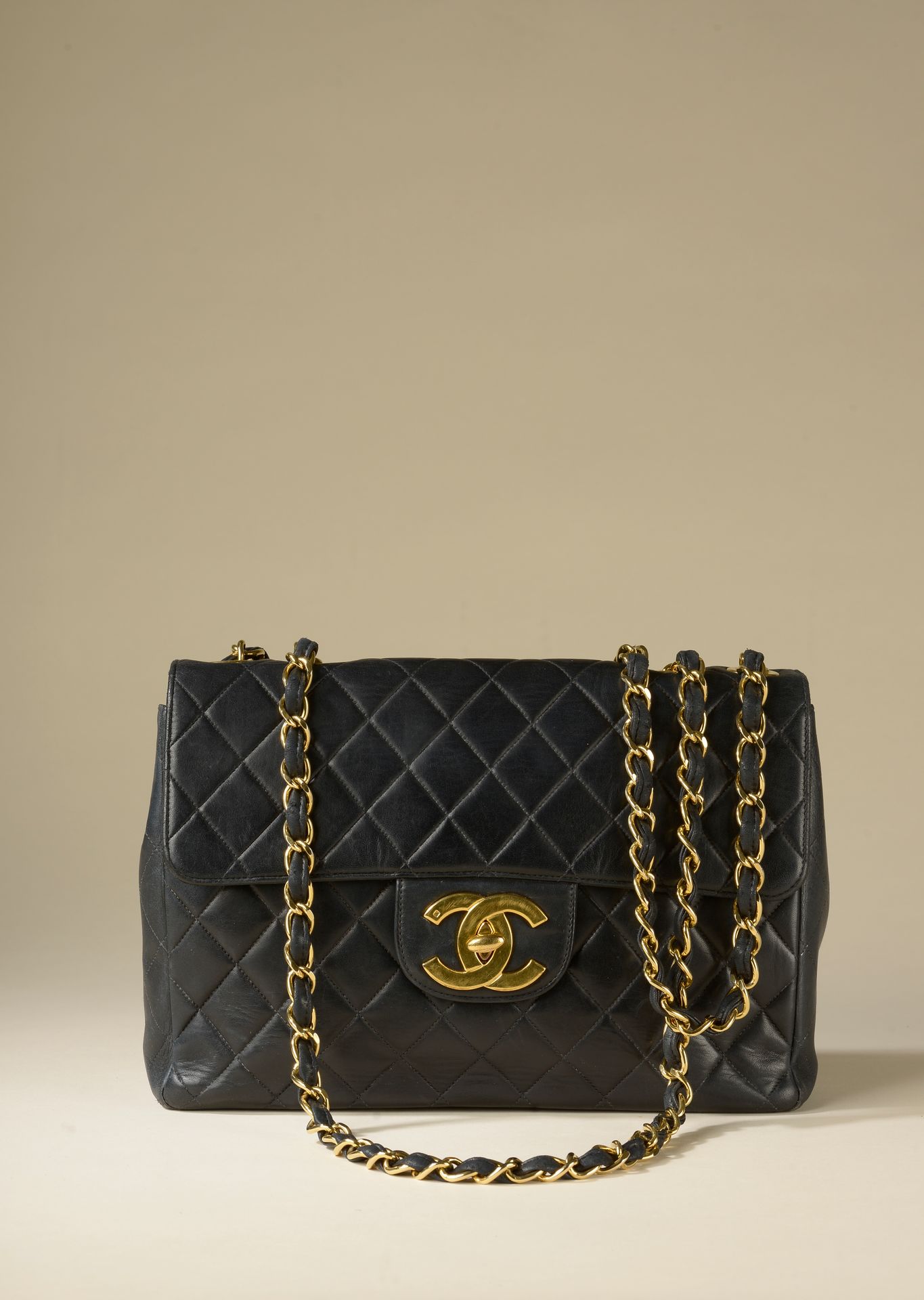 CHANEL. Jumbo bag in smooth quilted black lambskin, go…