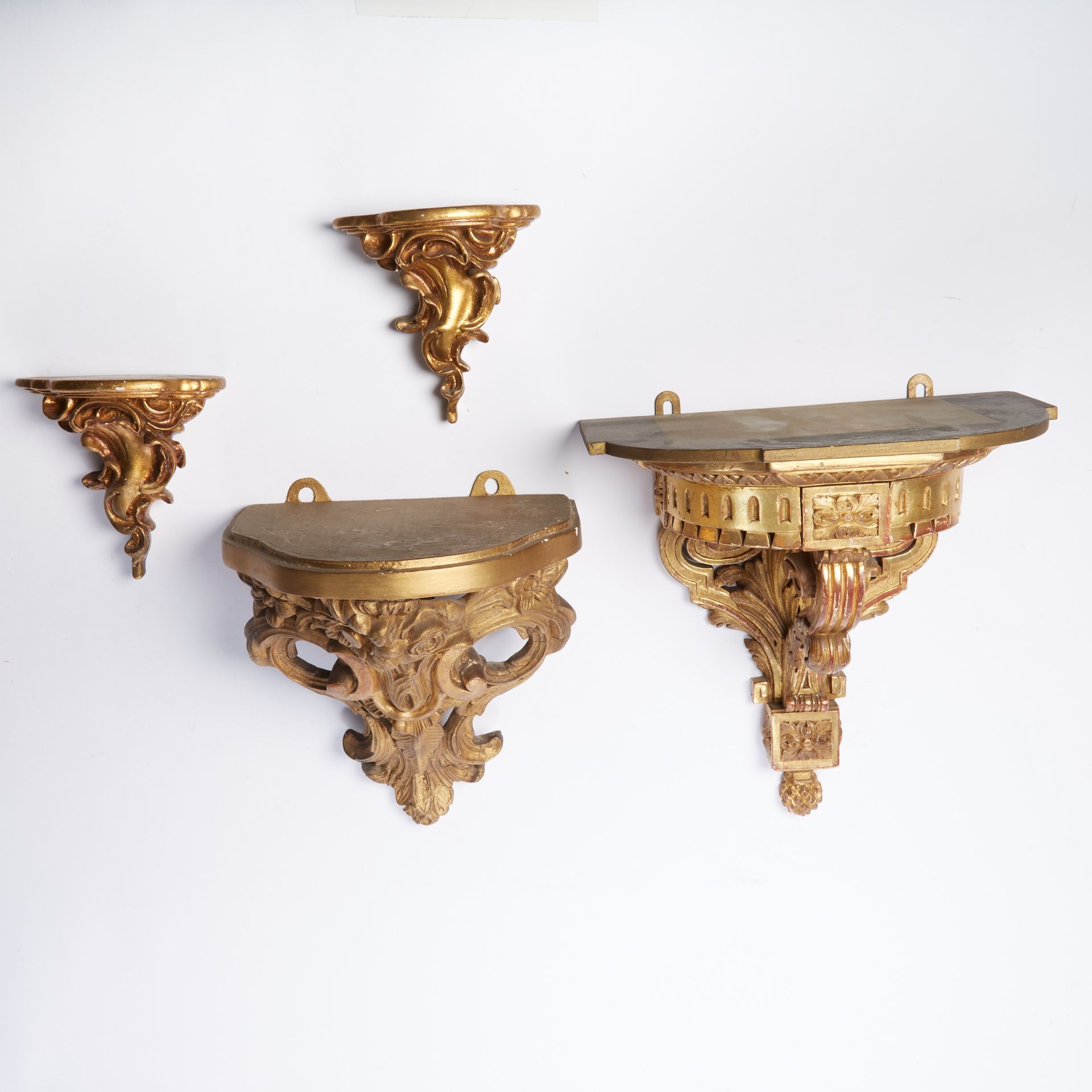 Null A set of two molded, carved, stuccoed and gilded wood consoles decorated wi&hellip;