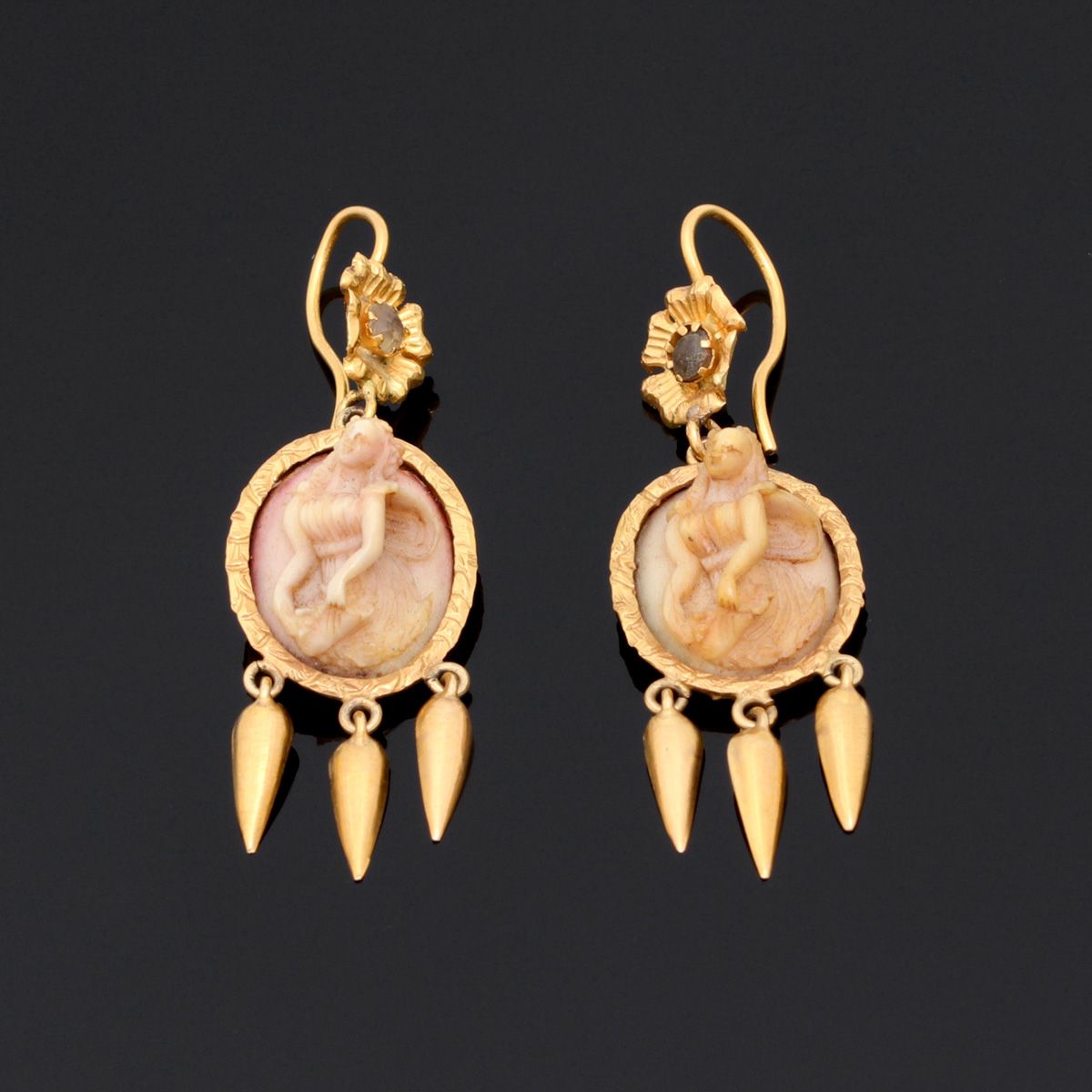 A pair of earrings A PAIR OF EARRINGS Gold structure, unmarked, with ivory in re&hellip;