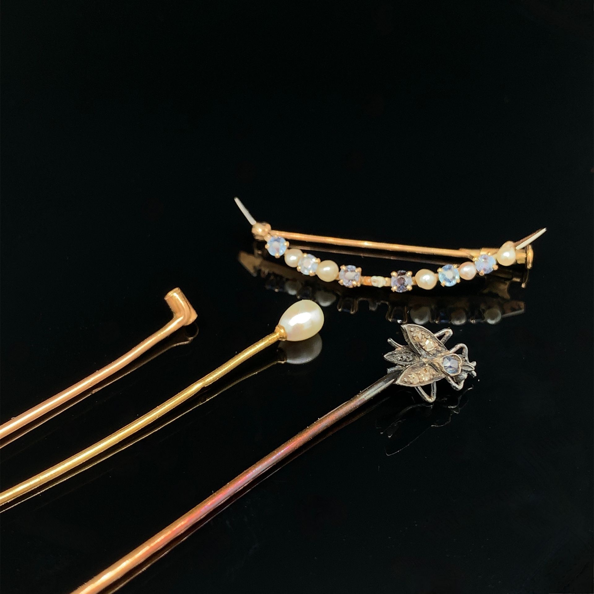 Null 黄金(750‰)拍品包括：
- 一个 "新月形 "宣传册，上面有一排精美的珍珠和蓝色宝石装饰。缺少珍珠。
有修复的痕迹。19世纪末。
长：4厘米 - &hellip;