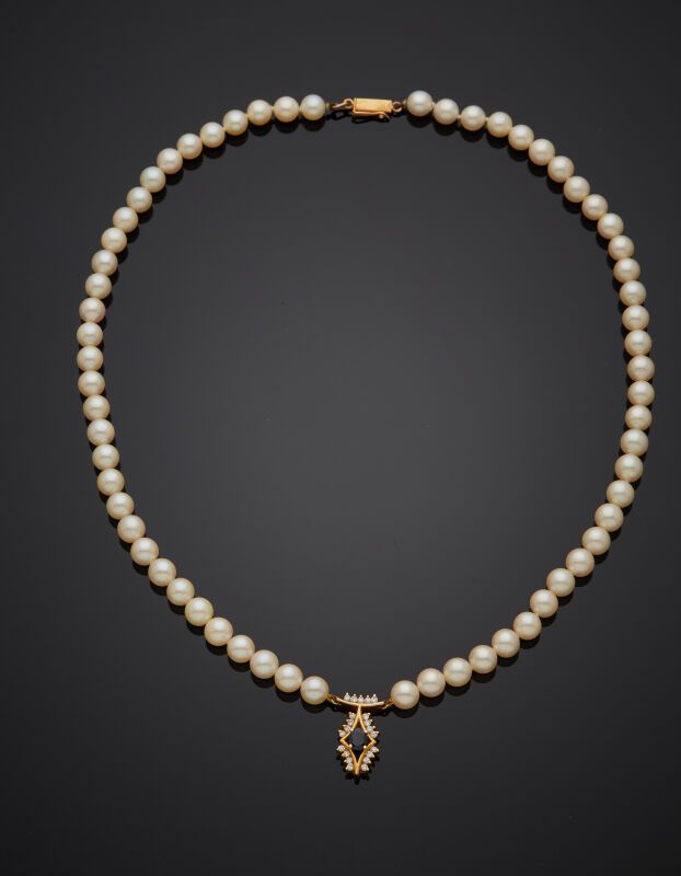 Null COLLIER composé d'un rang de perles de culture blanches, retenant un motif &hellip;