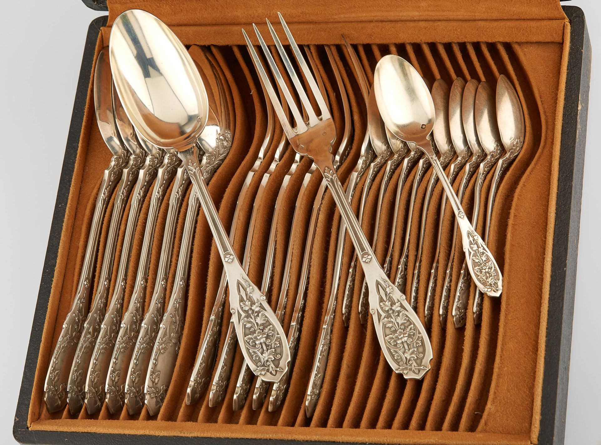 Null Seven large silver flatware and ten small spoons chased with flowering stem&hellip;
