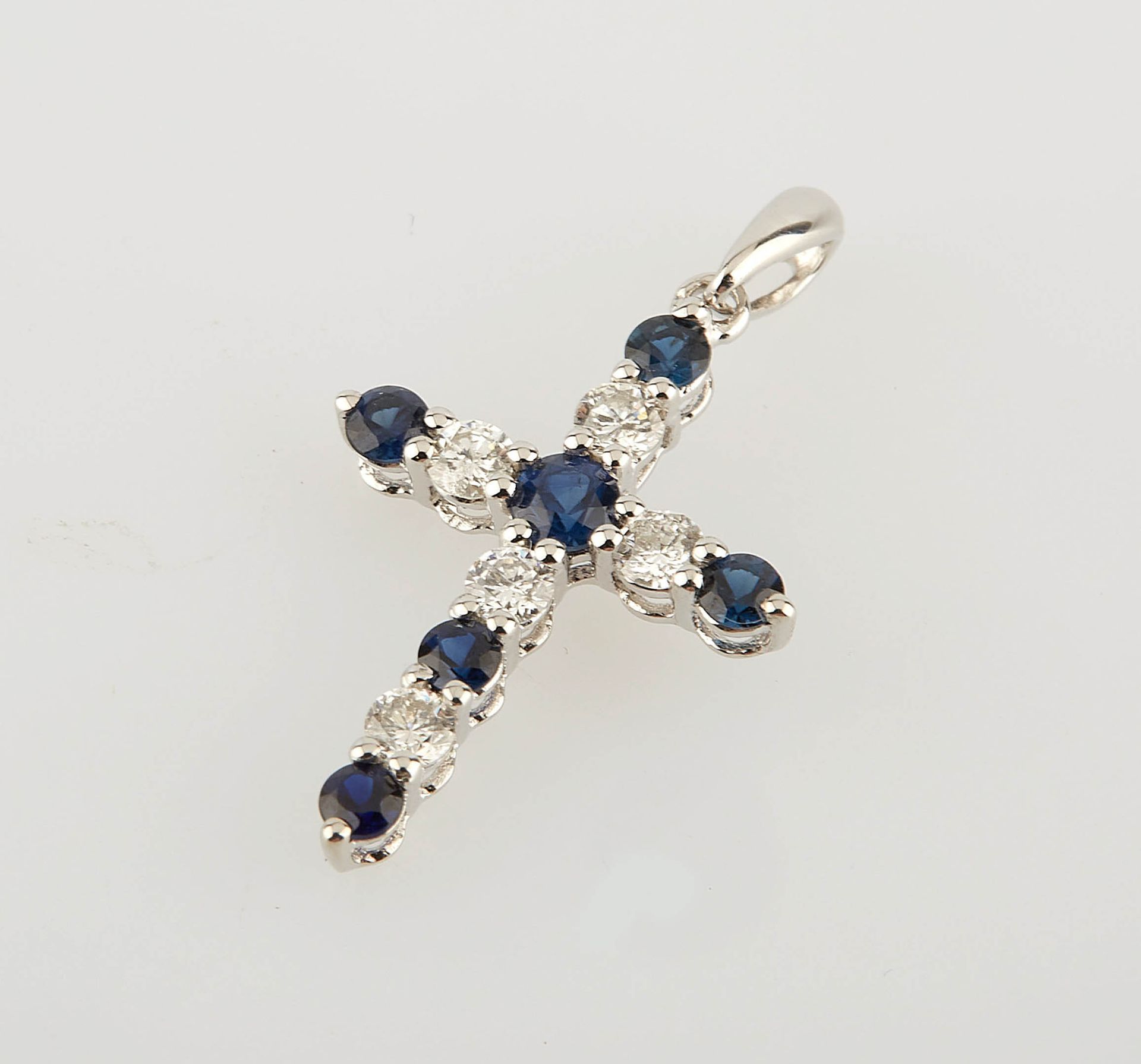 Null White gold cross set with six sapphires for 0.30 ct. And five round diamond&hellip;