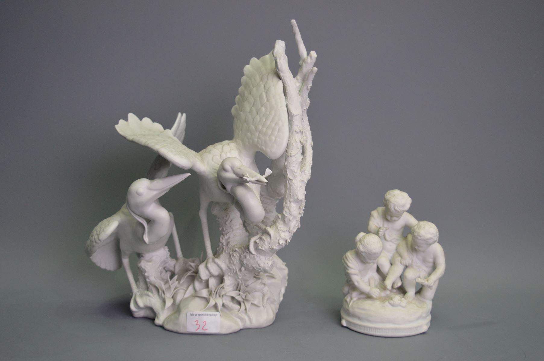 Null Two statuettes in cookie, birds and children, Ht: 34 and 15cm