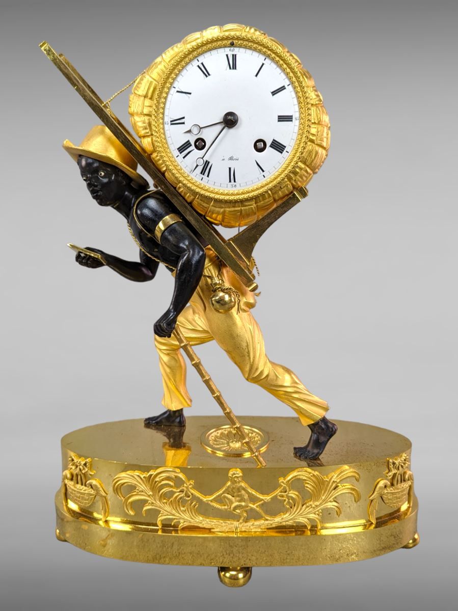 Null Chased bronze clock with an African cross-bearer - black and golden patina &hellip;