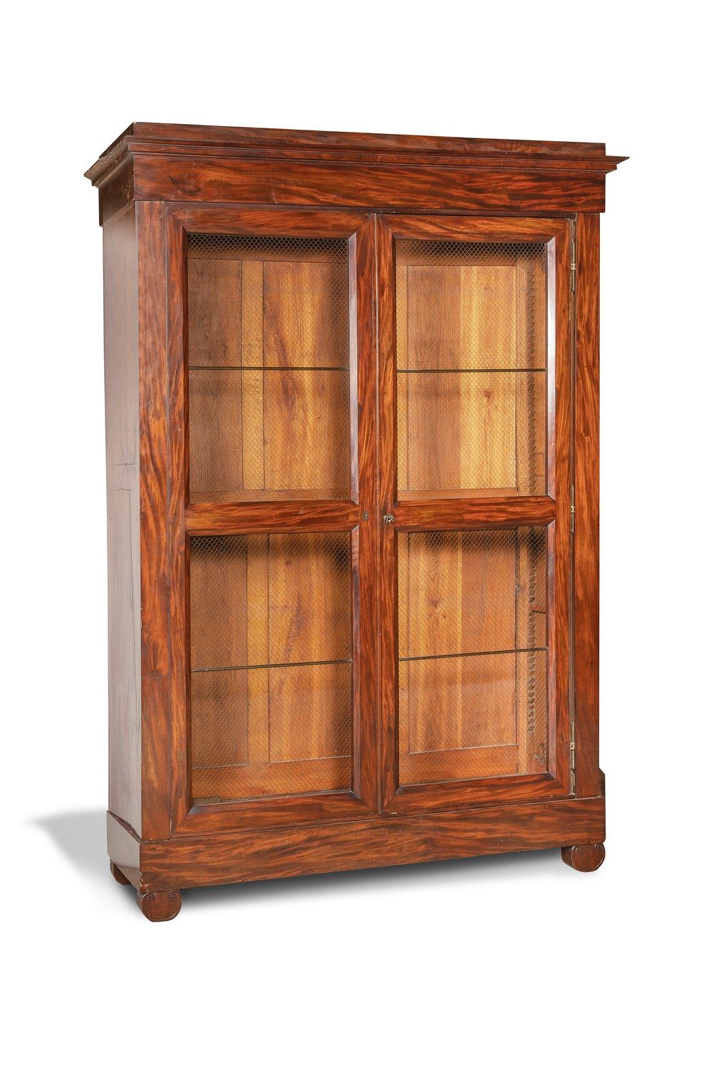 Null 桃花心木和桃花心木饰面的书柜，开口处有两个斜面的烤漆叶。搁置在圆形腿上。突出的檐口。

19世纪的前三分之一。

H.250厘米。 宽174.5厘米。&hellip;