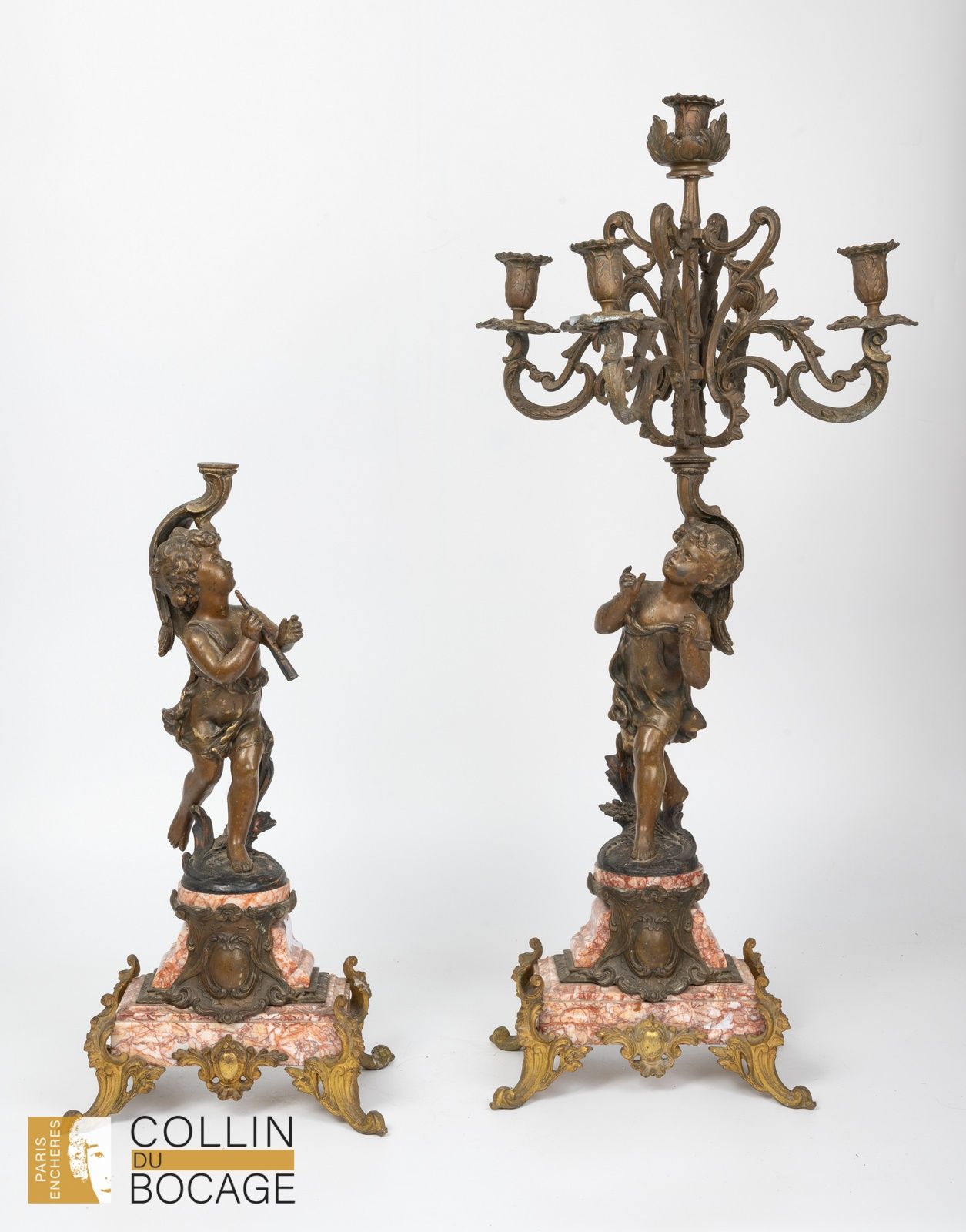 Null Pair of five-light candelabra in regule with putti musicians.
(one arm to b&hellip;