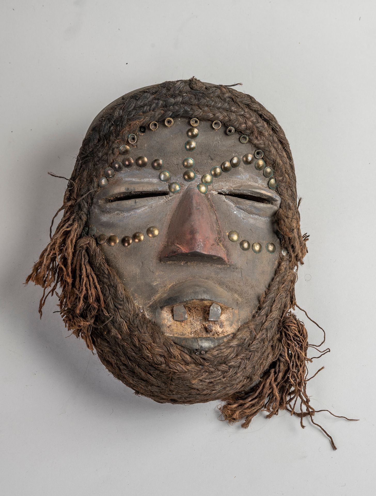 Null 
Ivory Coast, GUERE WOBE mask in patinated wood inlaid with textile, nails &hellip;