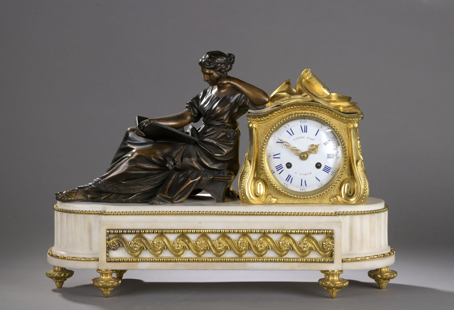 Null Gilt bronze and white marble mantel clock

featuring a lady reading in brow&hellip;