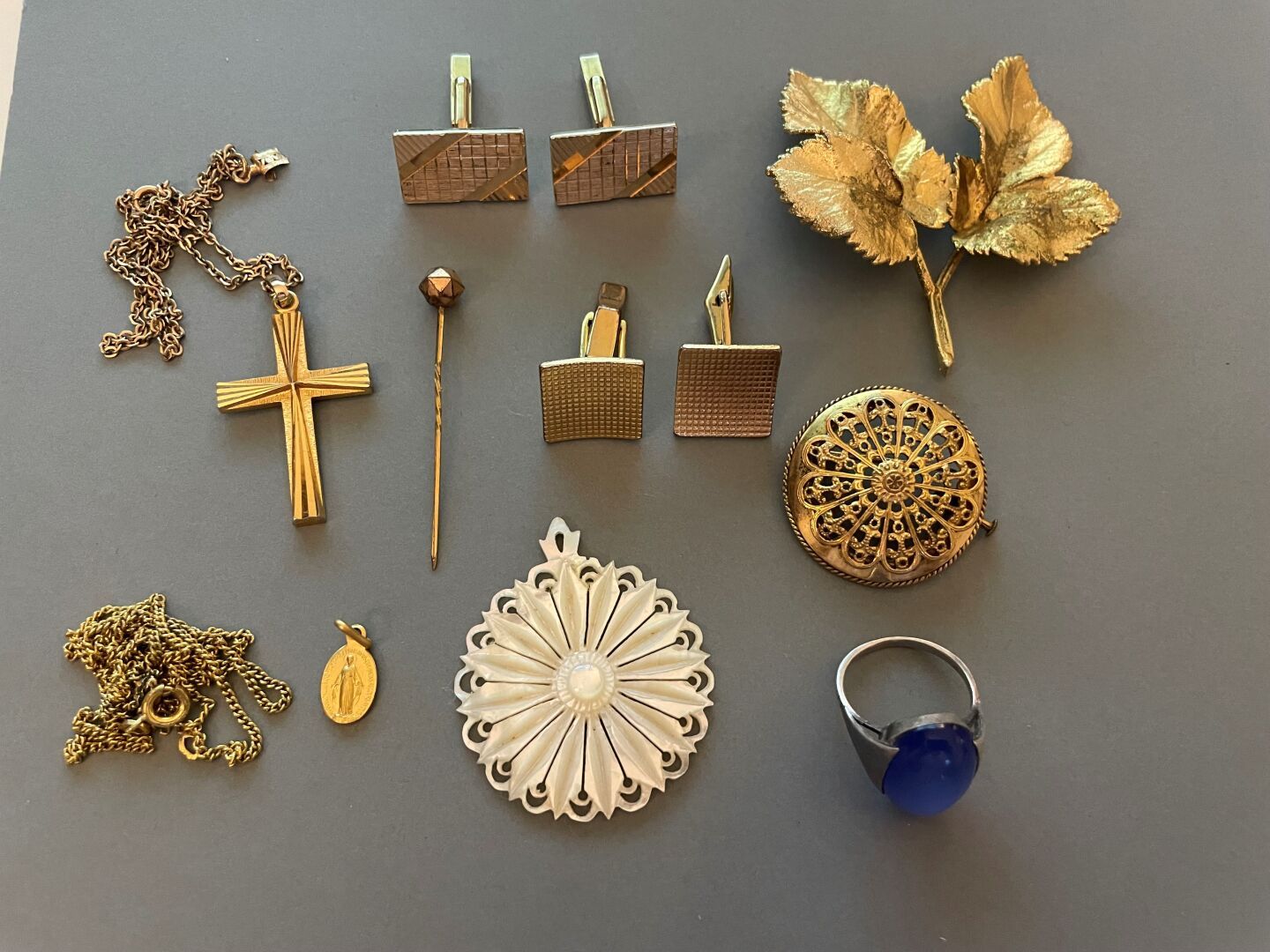 Null Lot of costume jewelry including a pair of gold-plated cufflinks.