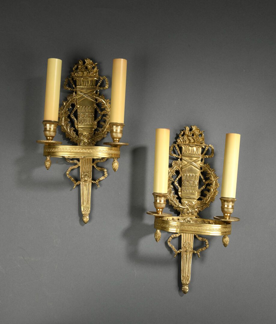 Null Pair of gilt bronze sconces, the shaft simulating a torch, formed into a cr&hellip;