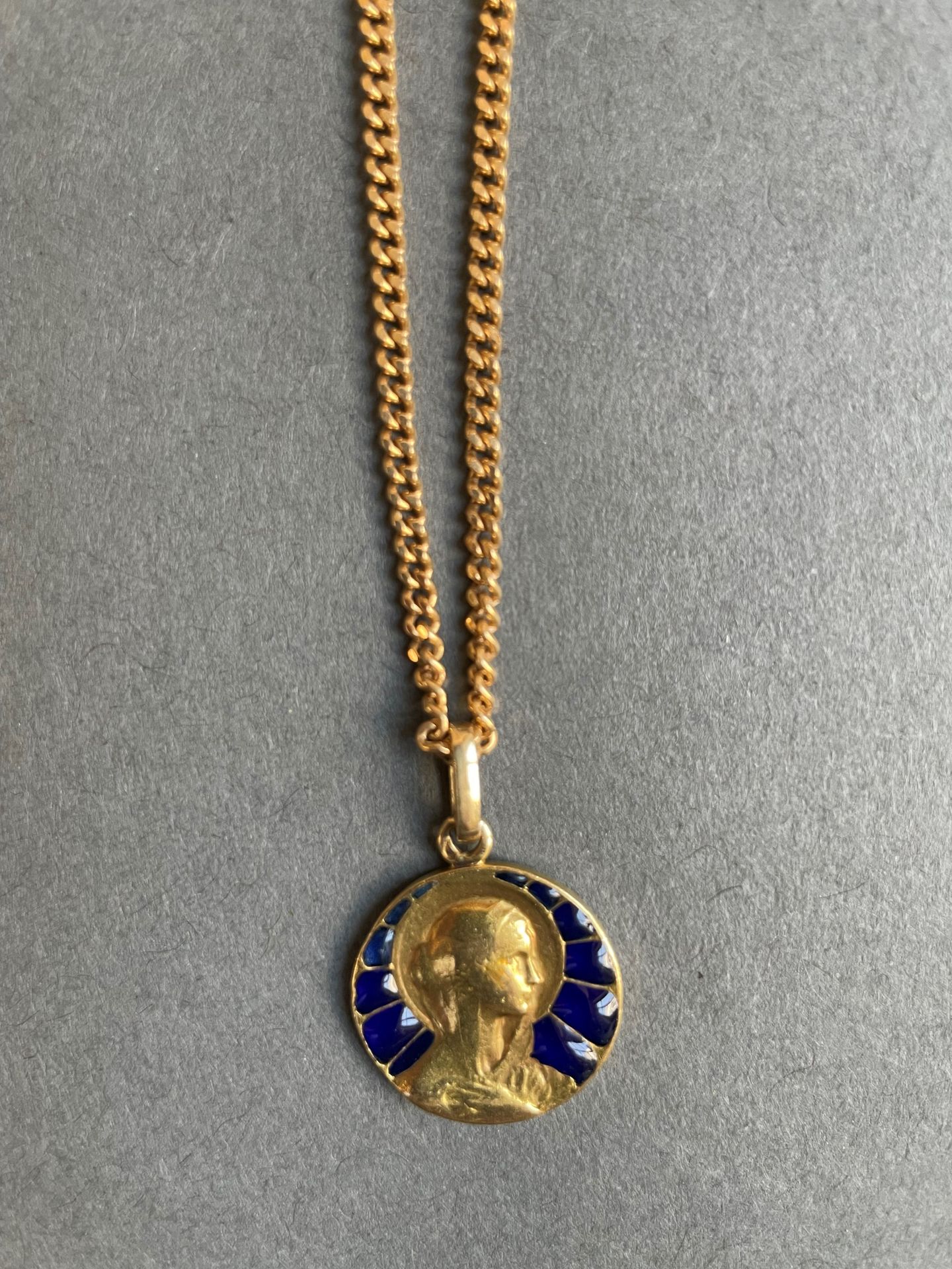 Null 黄金链子上有一枚圣母玛利亚的黄金奖章，部分为蓝色珐琅彩（雕刻）。
总重量：21.7克。- 链长：71厘米