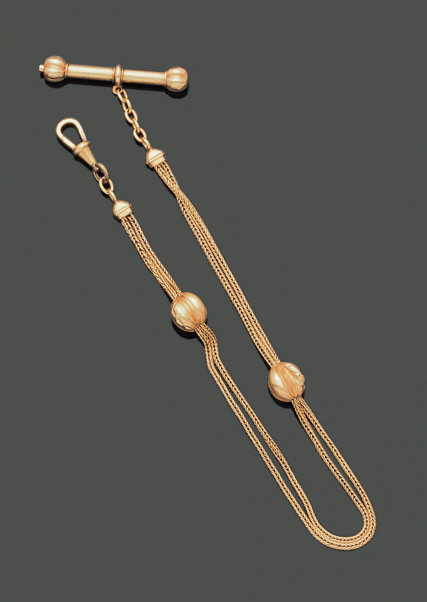 Null 18K（750）黄金马甲链，由两条带罗纹的链子组成，并配有其带玑镂装饰的钥匙，末端有罗纹。卡钩是由金属制成的。毛重：19.65克。