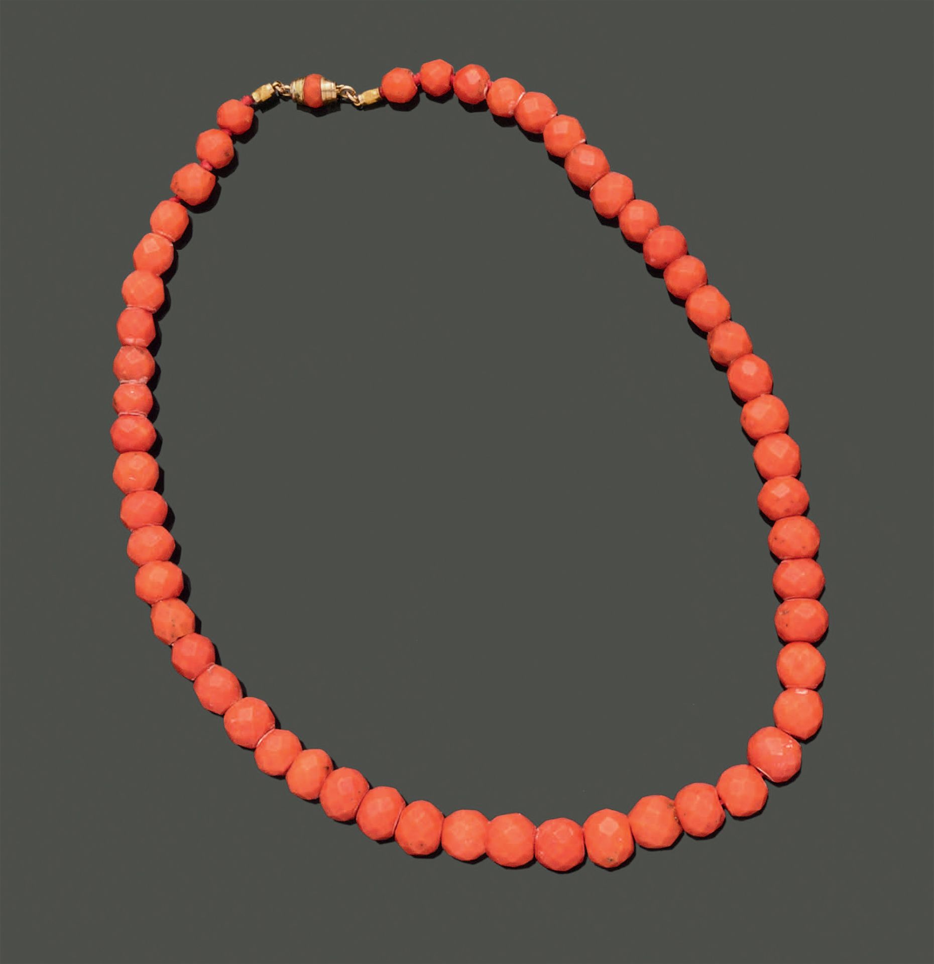 Null Necklace made of faceted coral beads, the clasp in 18K (750) yellow gold.