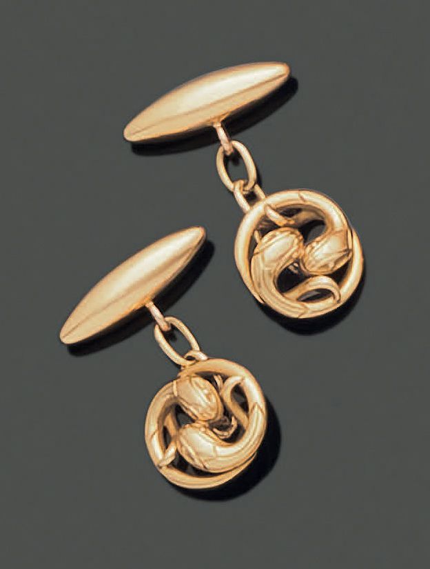 Null 一对18K(750)黄金袖扣，其中一个圆形的元素穿孔并刻有两个蛇头相向。扣子是橄榄色的。重量：11.15克。