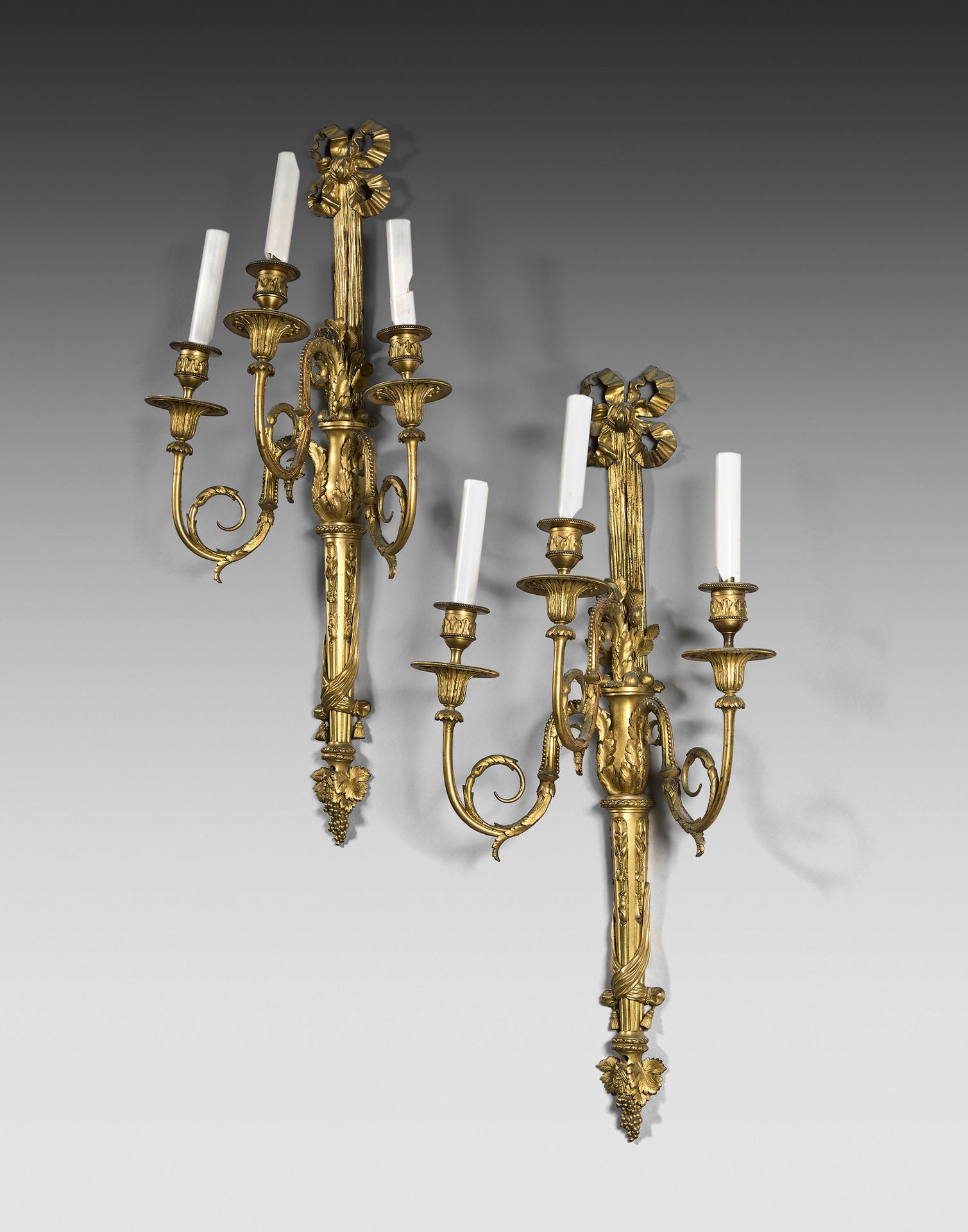 Null Pair of large three-light sconces in chased and gilded bronze, the shafts i&hellip;