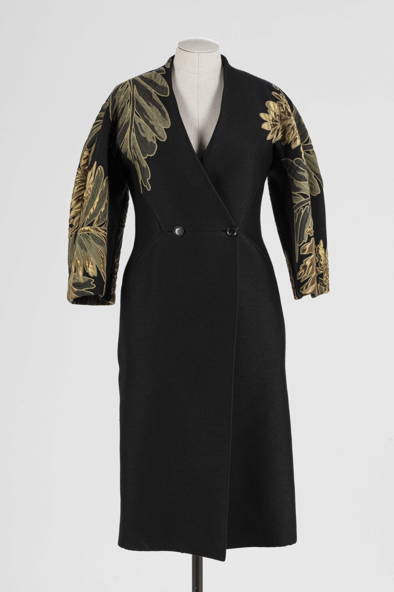 Null 
GUCCI：黑色羊毛大衣，袖子上有金色叶子的风格化图案，单排扣，两个侧袋。





T.34
