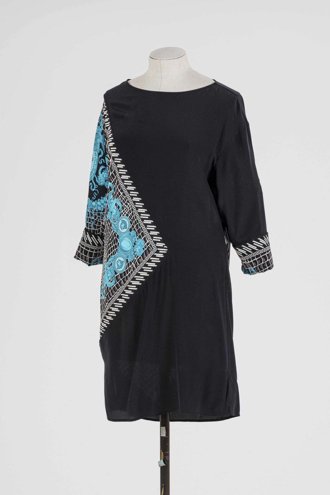 Null VERSACE：黑色丝绸长衫连衣裙，上面有造型怪异的蓝白花朵和树叶图案，3/4长袖。

T.38