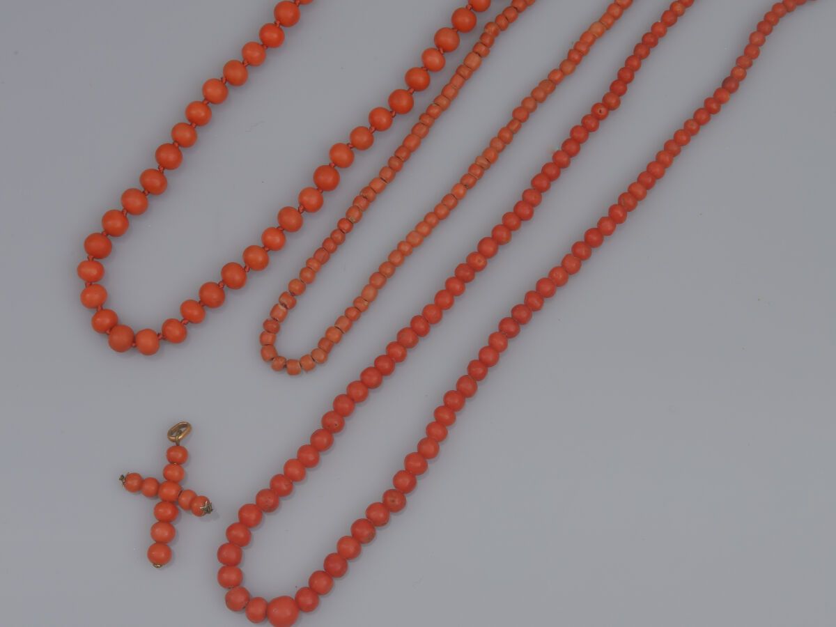 Null 63.一套三个小女孩的项链，由珊瑚珠制成
珊瑚珠，其中一个是坠子，两个18K（750）金的扣子
和一个银制的。
最小和最大长度：约30至42厘米。
毛&hellip;