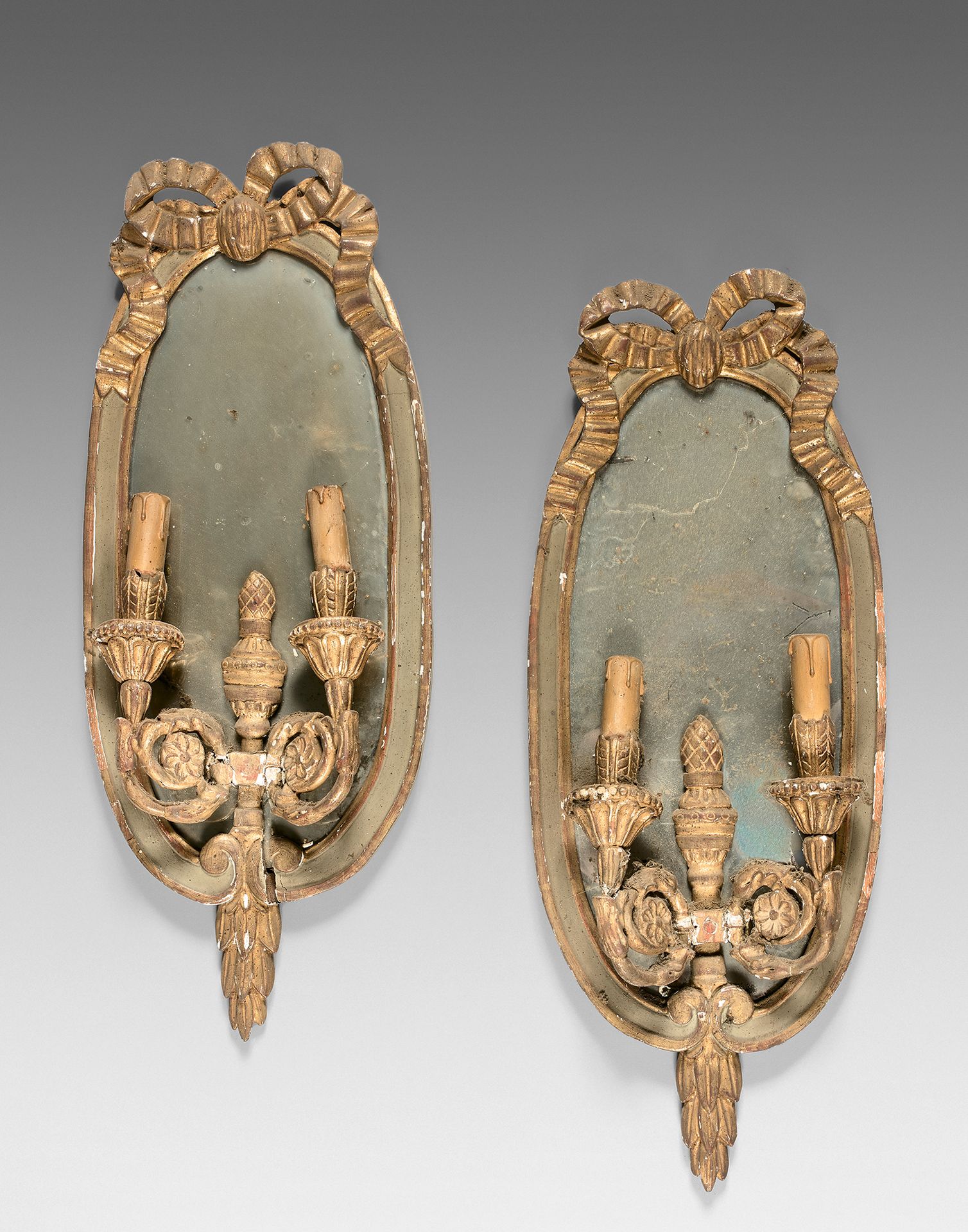 Null 一对有两个灯臂和一个镜子背景的壁炉。
路易十六风格，19世纪，有一个木制的雕刻着结的门框。