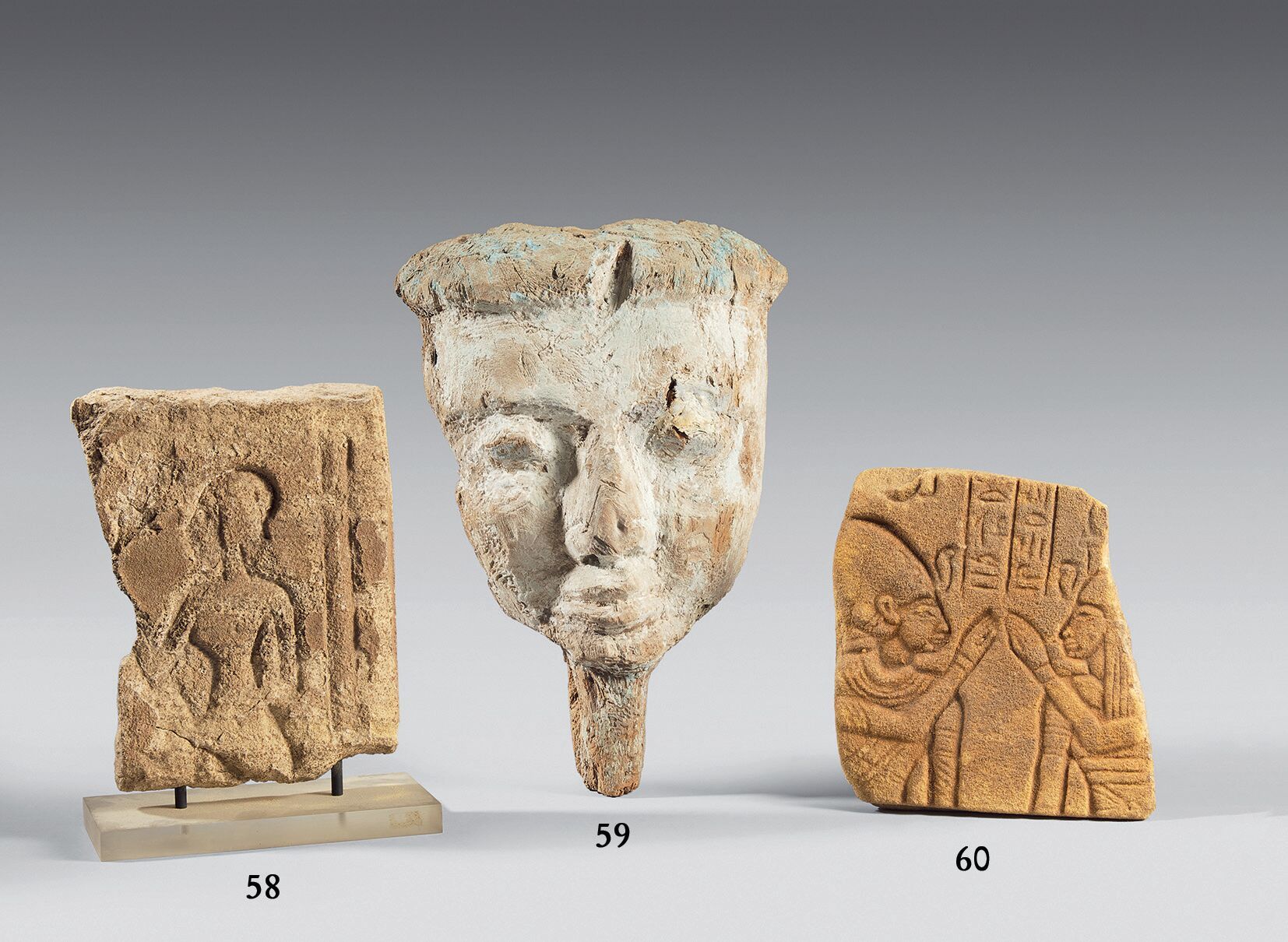 Null 残缺的浮雕，装饰着两个面对面的人物，两边是象形文字的铭文。 
砂岩。 
埃及，阿玛尔尼风格。 
尺寸：18 x 16厘米