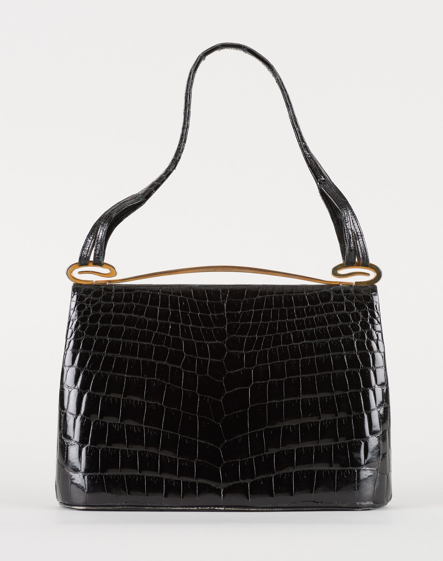 Delvaux. Leather goods: Handbag in black crocodile skin, gold trim, suede lining&hellip;