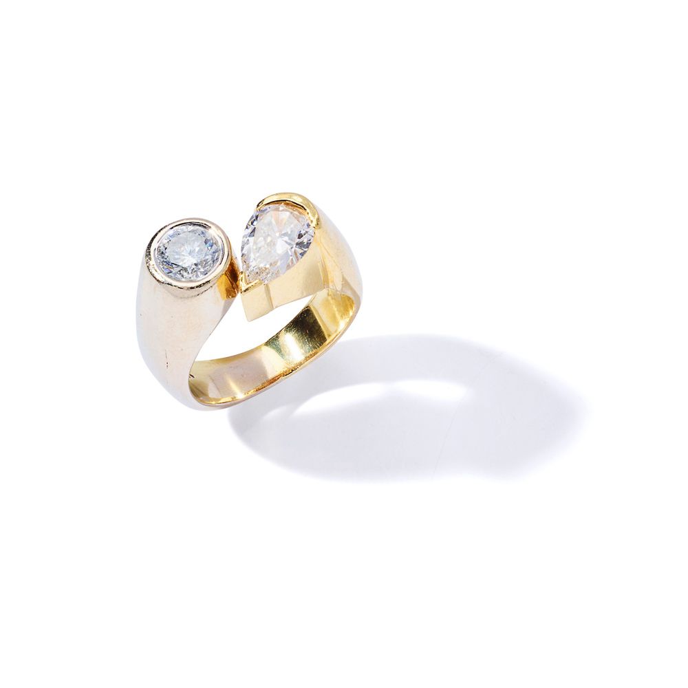 A diamond two-stone ring Collet-set with a brilliant-cut and a pear-shaped diamo&hellip;