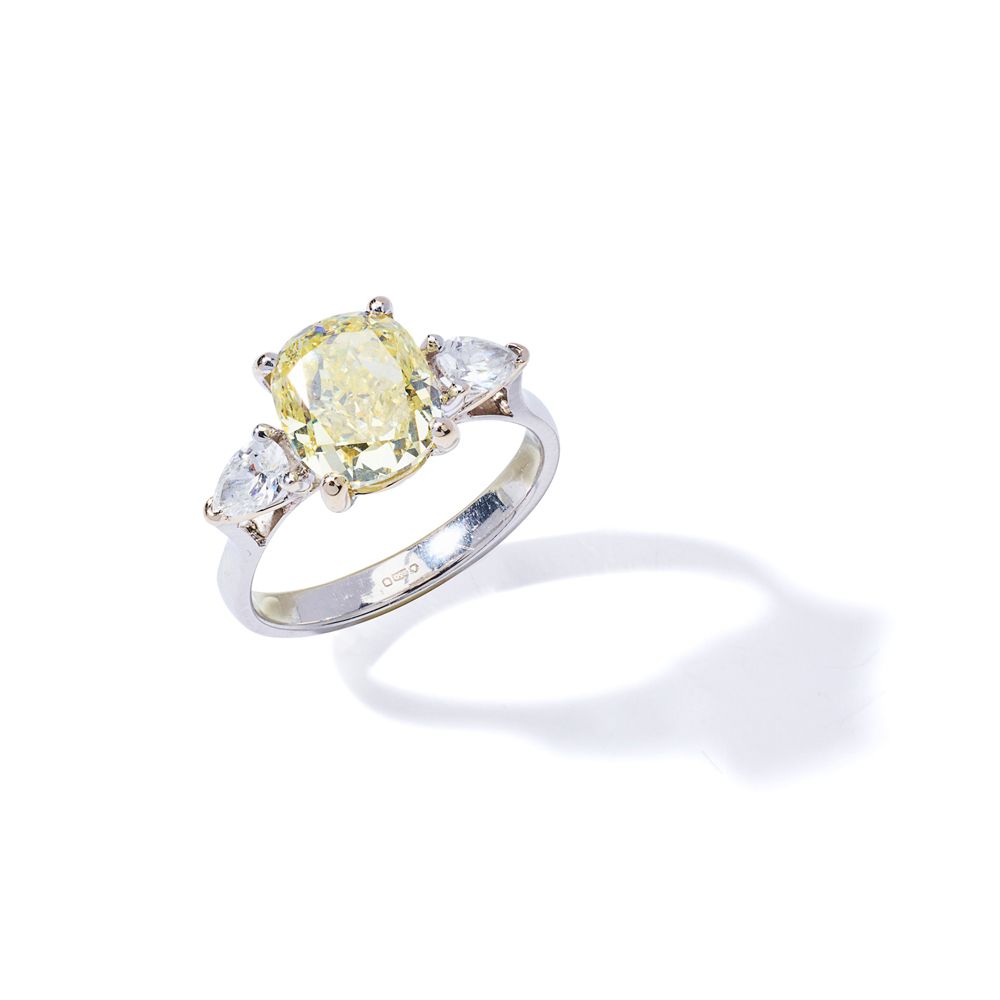 A fancy-coloured diamond ring Le diamant jaune de fantaisie de forme coussin, pe&hellip;