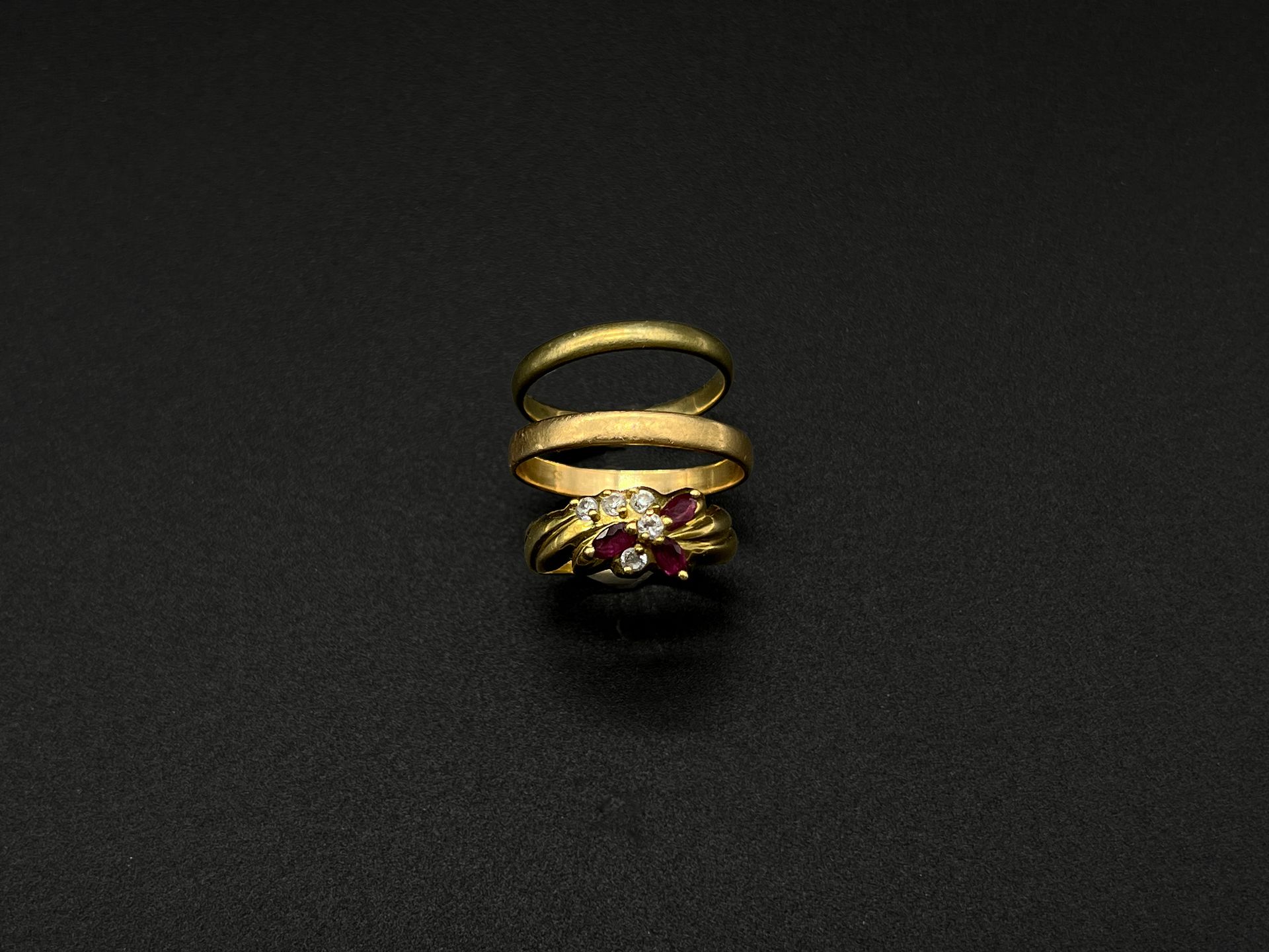 Null 一批戒指包括:

- 两个黄金（750）结婚戒指。

总重量：4克。

- 一枚黄金（750）戒指，装饰有粉色和白色宝石的造型花。

毛重：2.4克。