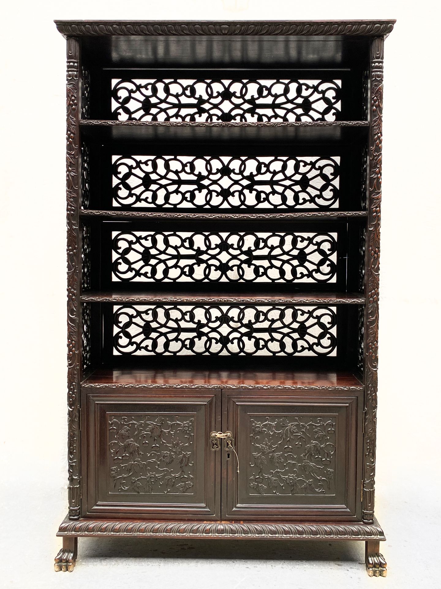 Null ASIA, Late 19th century 

Bookcase in stained wood richly carved opening to&hellip;