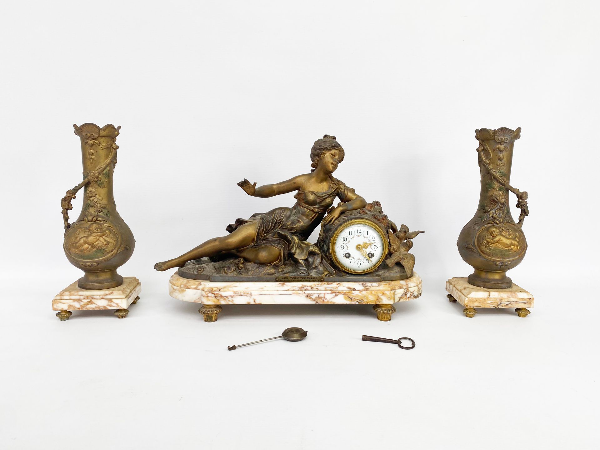Null 20世纪的作品，在莫罗兄弟之后

雷古拉和大理石壁炉套装包括:

-一个带着燕子的优雅女人的时钟

-两个花瓶，有花卉和普蒂装饰。

高钟：31厘米
&hellip;