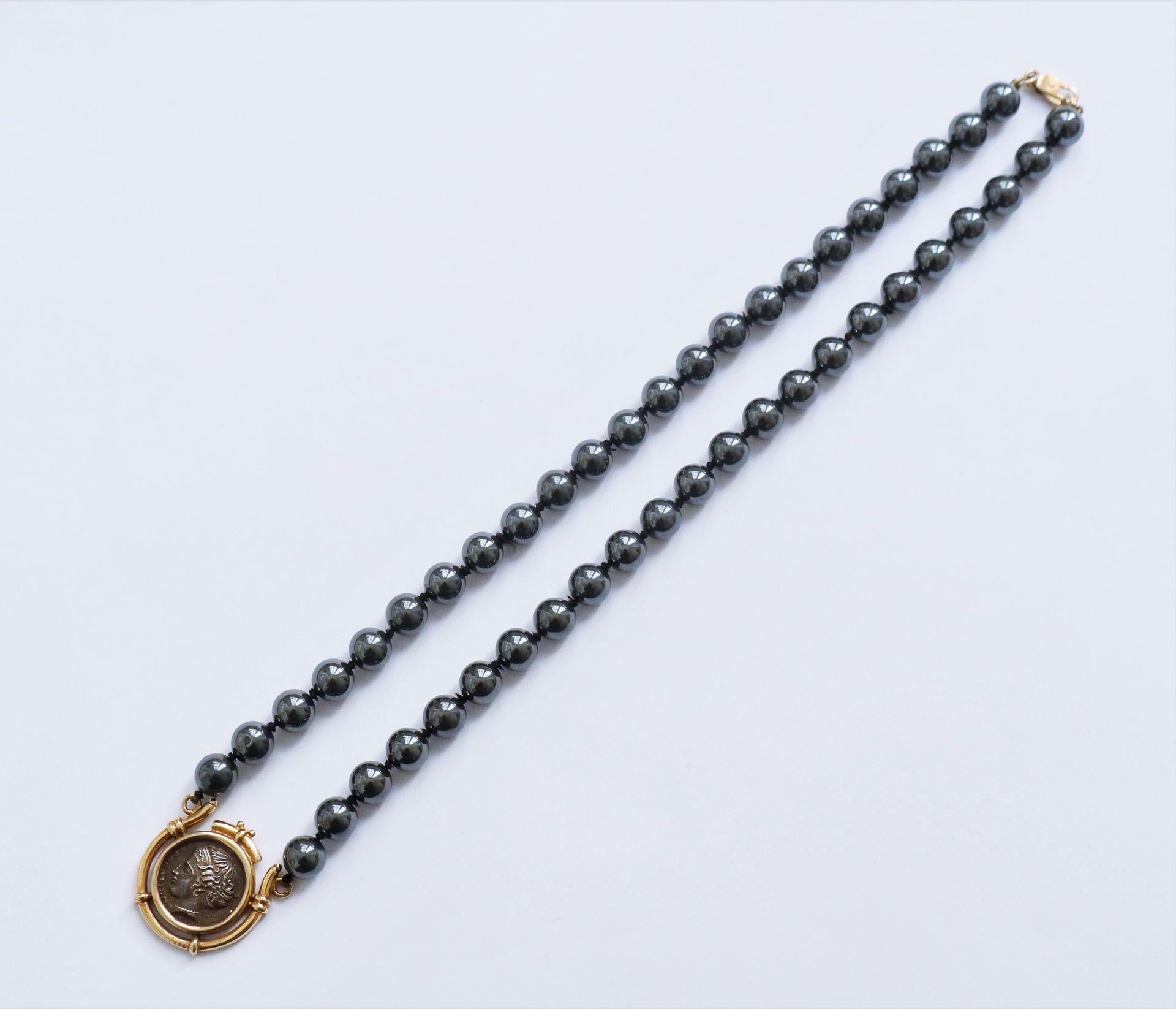 Null Necklace of hematite beads set with a silver coin mounted in 14K gold (585)&hellip;