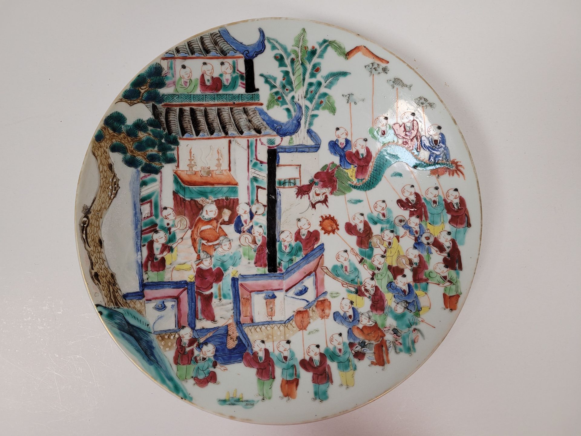Null 瓷盘，中国，19世纪末-20世纪初
一个多色的装饰表现了一个节日的场景
。
珐琅质的小缺口。
直径：33.8厘米