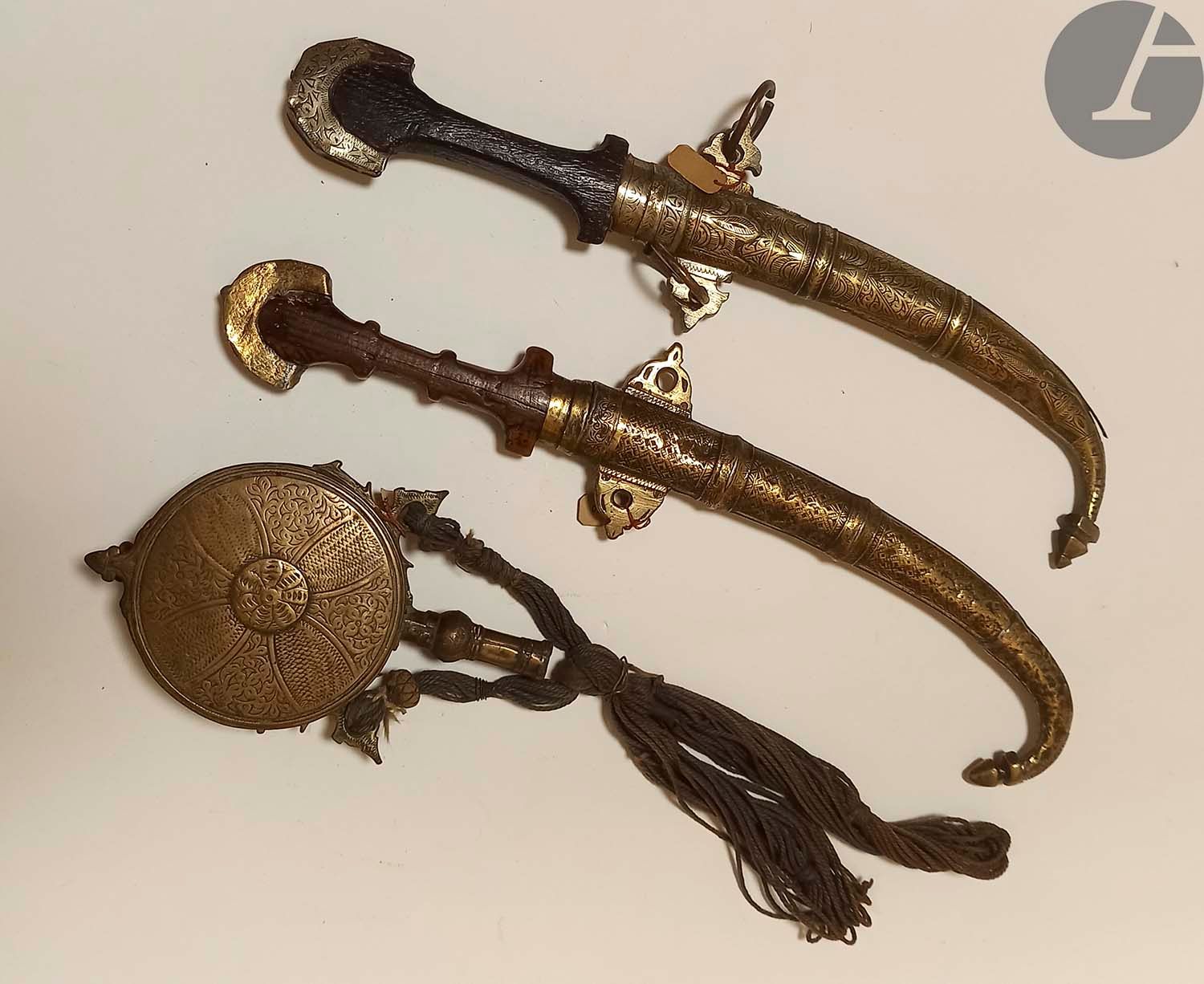 Null Set including : 
- Two Koumyah daggers. Wooden handles. Brass scabbards. 
-&hellip;
