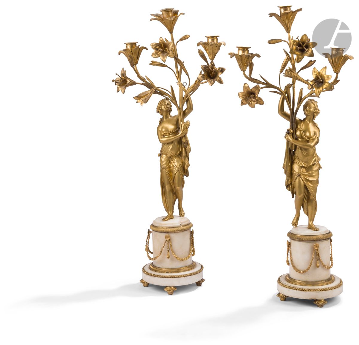 Null 一对白色大理石和鎏金青铜三灯烛台，上面有披着衣服的女人，放在珍珠和花环的底座上；（小事故和磨损）。
19世纪中期。
高：68厘米