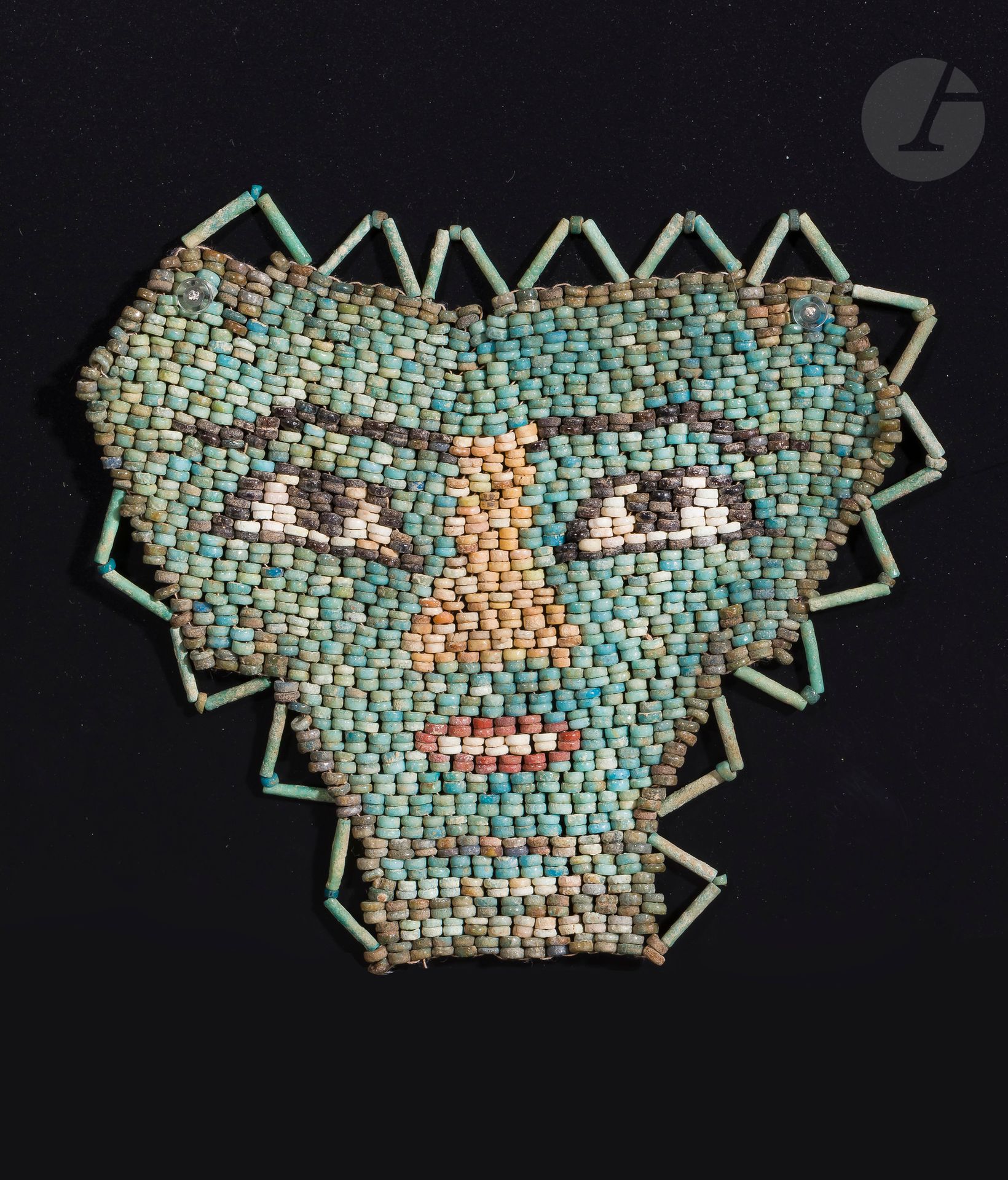 Null Mummy's net showing a mask
Modern assembly. 
Polychrome earthenware. 
Egypt&hellip;