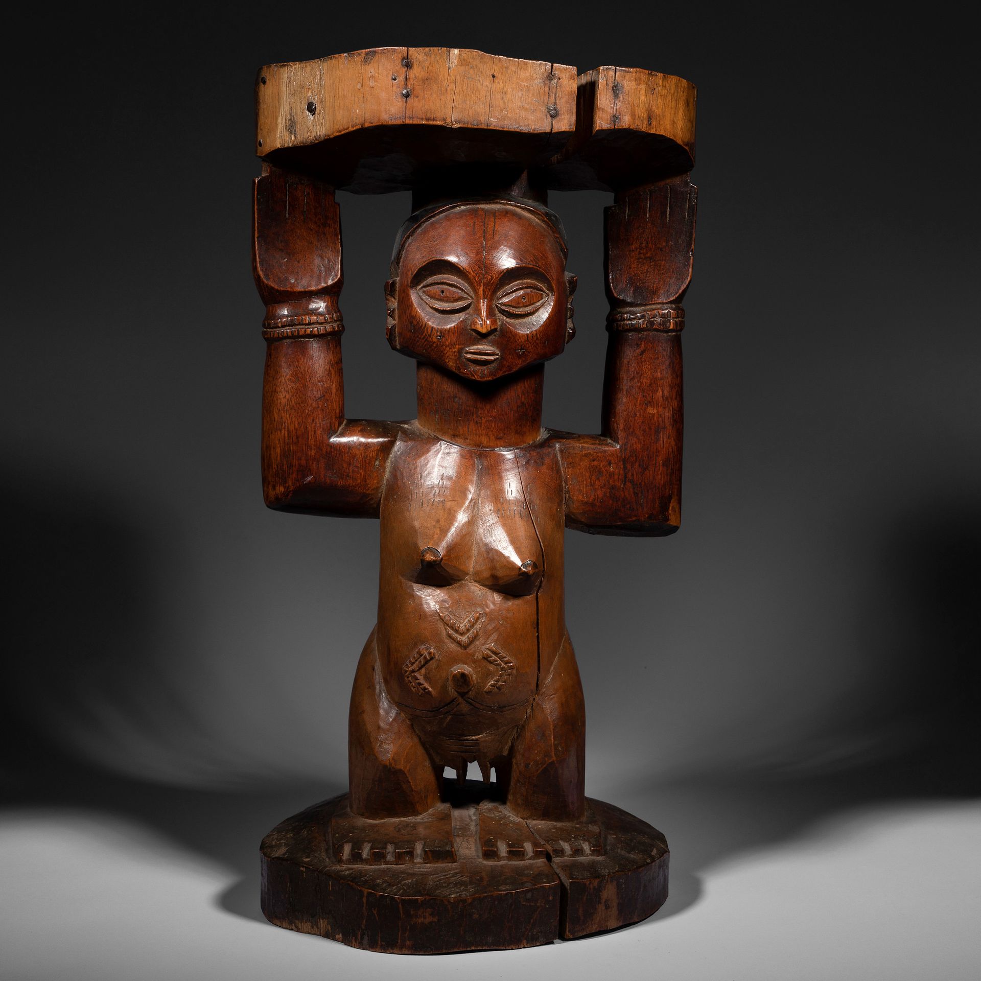 Null A chief's stool, a caryatid seat, the female subject scarified on the body &hellip;