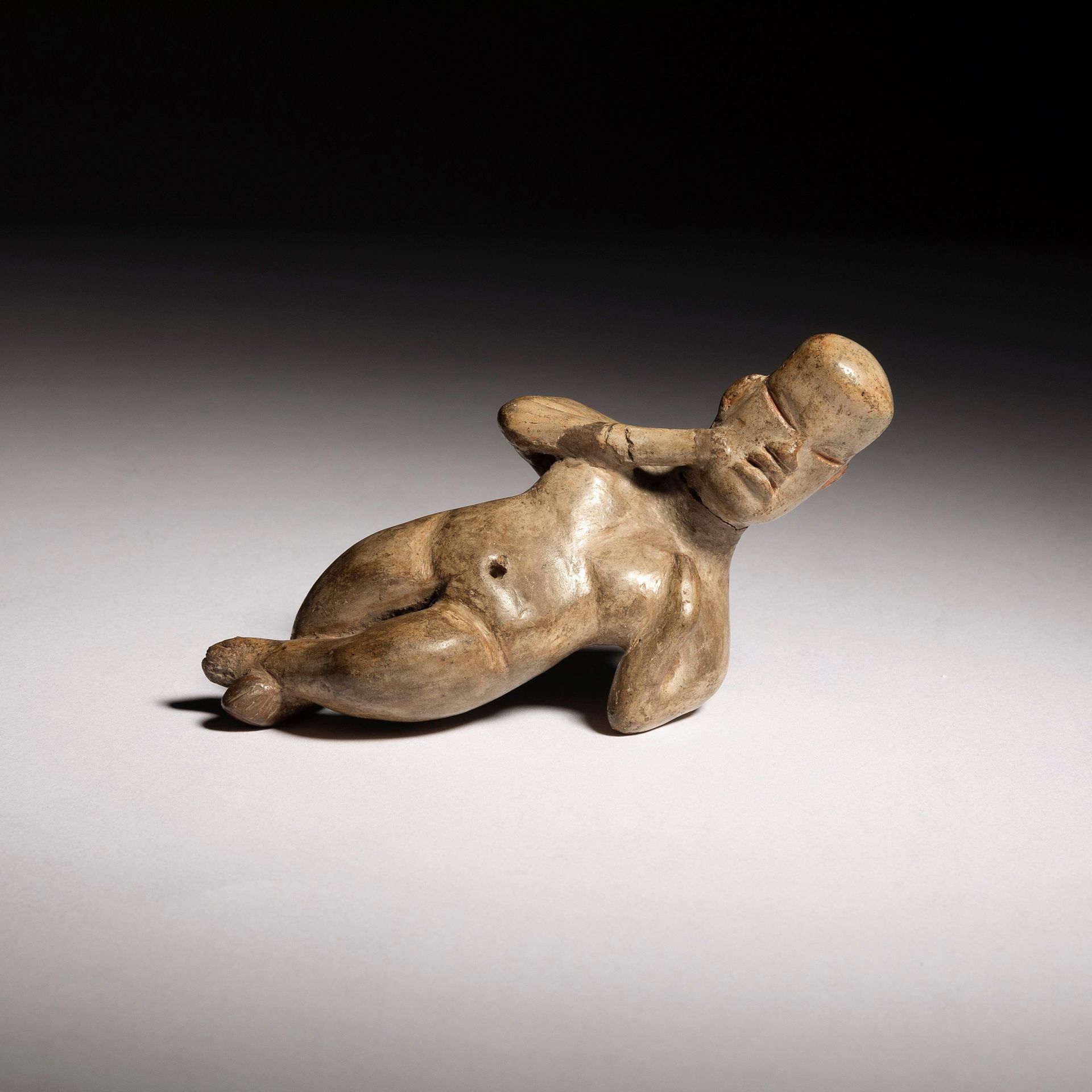 Null 一件美丽而罕见的雕像，表现了一个盘腿而卧的人物。

奥尔梅克文化，公元前900至400年，墨西哥

乳白色赤土，赭石色颜料，颈部和一只手臂上有明显的修&hellip;