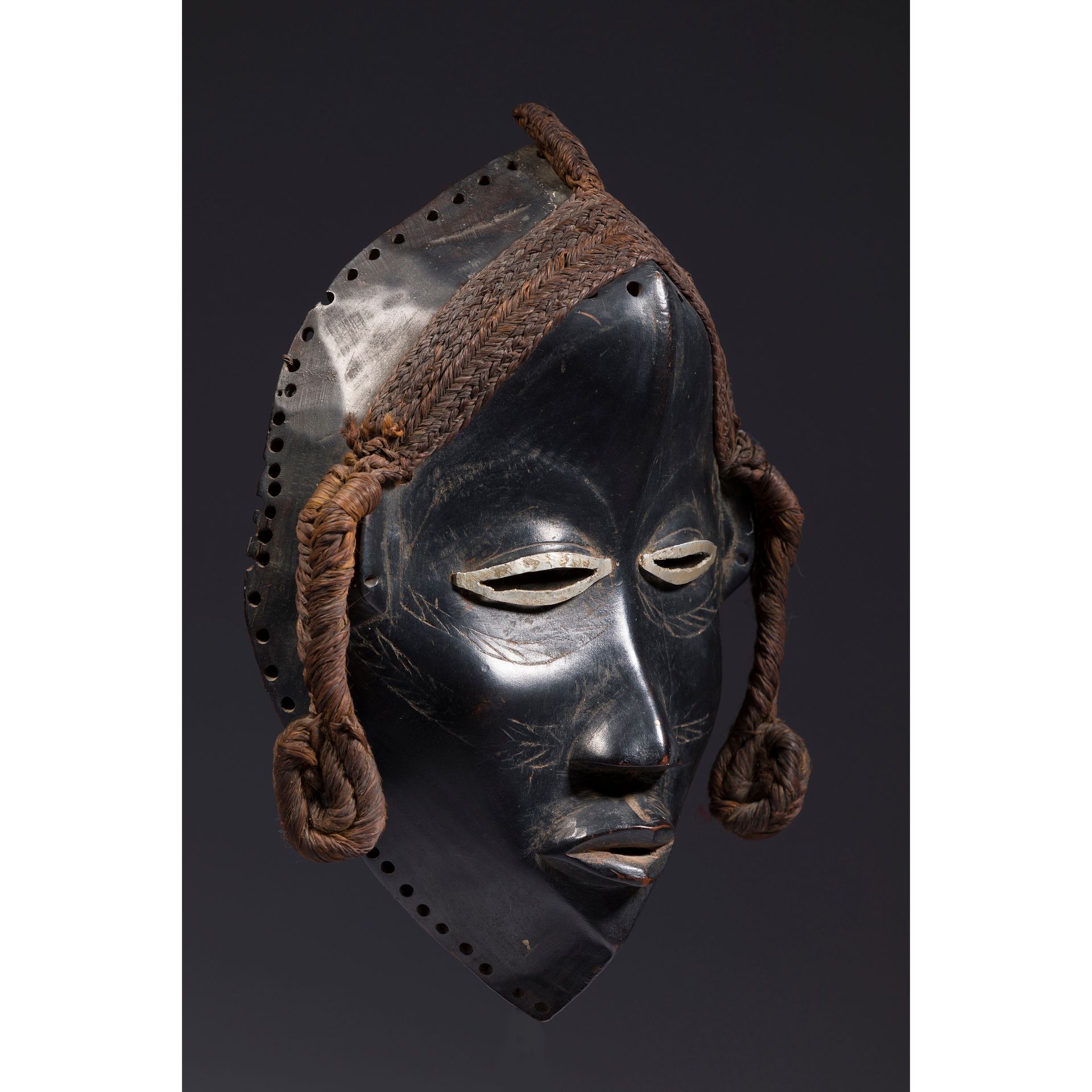 Null *An ancient mask with eyes encircled by tin, bearing carved scarification a&hellip;