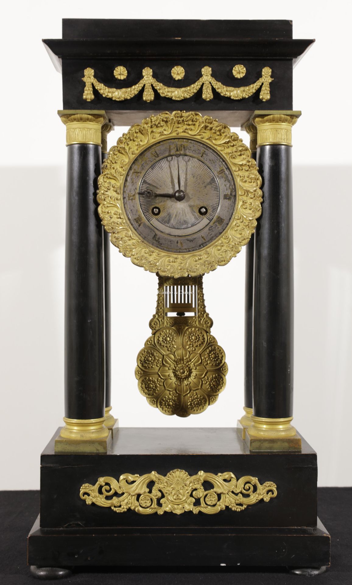 VARIA Empire mantel clock carried by four columns lacquered in black. Garniture &hellip;