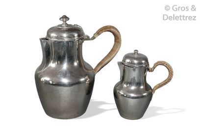 Two baluster-shaped jugs, in plain silver,...