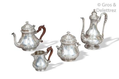 null Silver tea set consisting of a teapot, a milk pot and a sugar bowl resting on...
