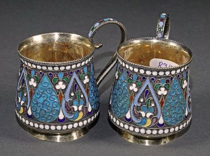 Pair of cups with handles resting on a light...