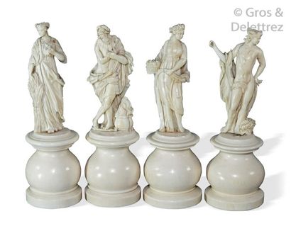 null A series of four carved ivory statuettes symbolizing the four seasons, the one...